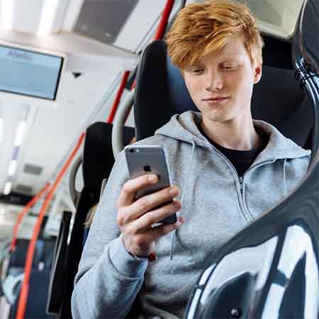 Passenger using smartphone on a bus